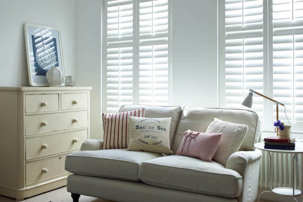 Living room shutters with light coming through blinds